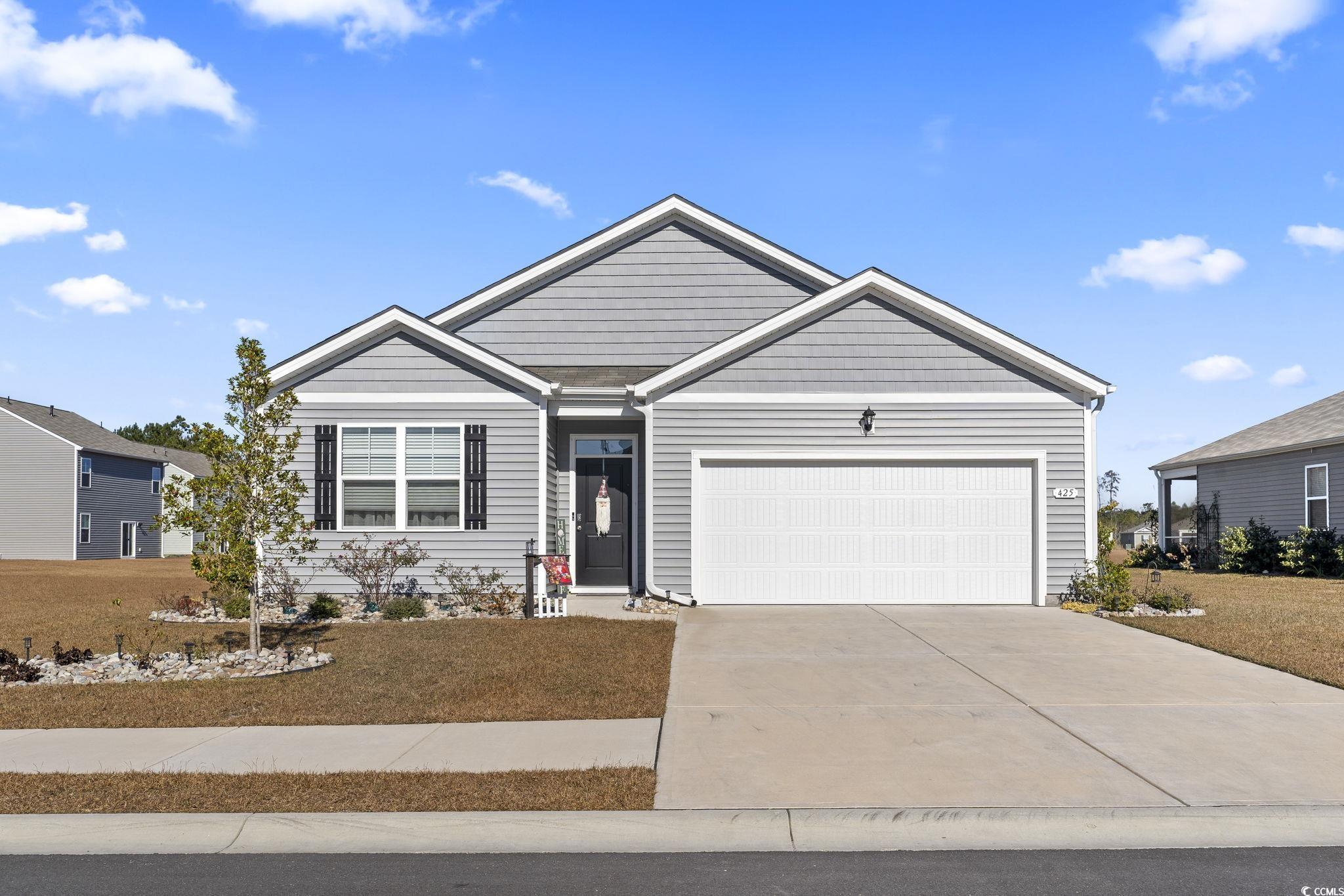 View of front facade featuring a garage