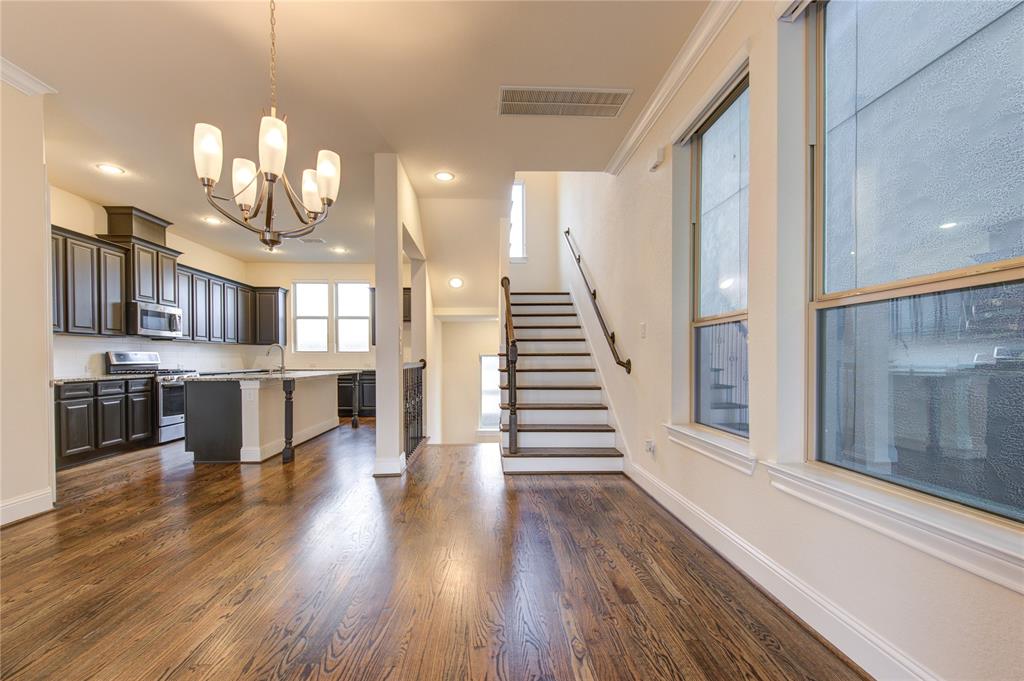 a view of a kitchen with cabinets and wooden floor