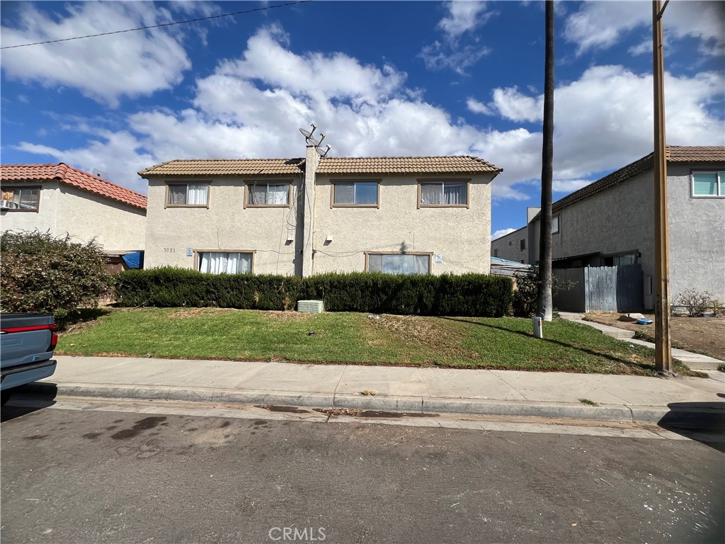 a view of a house next to a yard and road