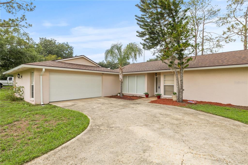 a view of a house with a yard and garage