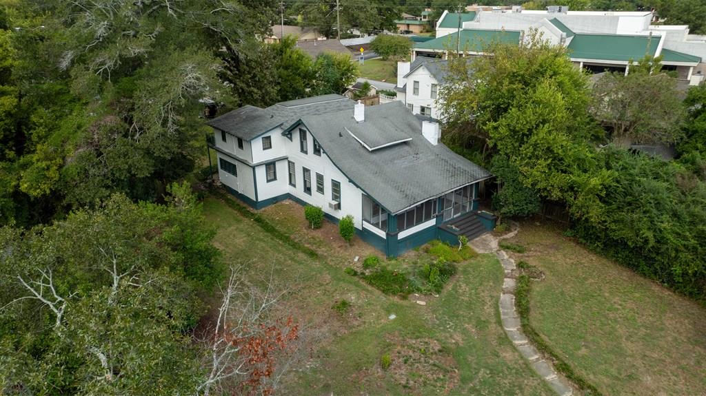 an aerial view of a house with a yard