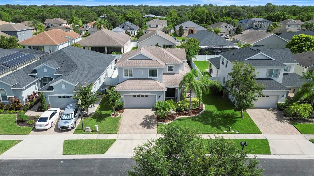 an aerial view of multiple houses with yard