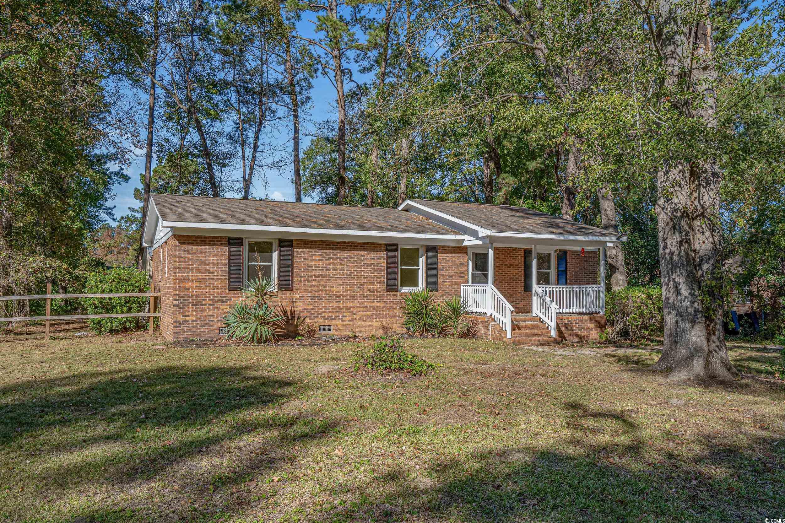 View of front of property with covered porch and a