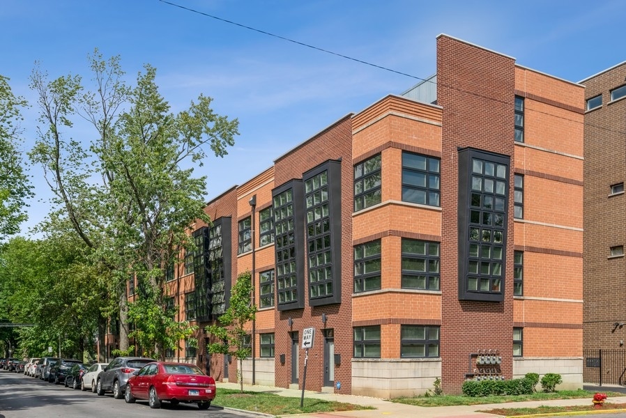 a front view of a building and car parked