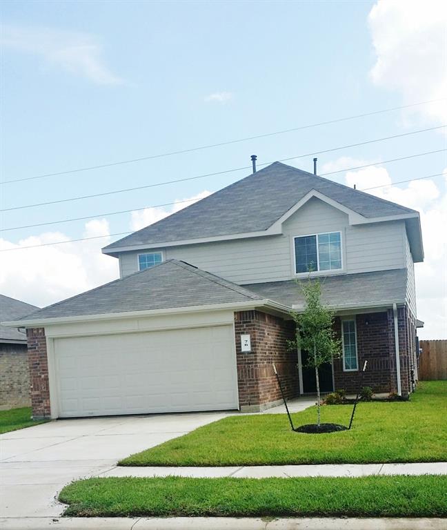 a front view of a house with a yard and trees