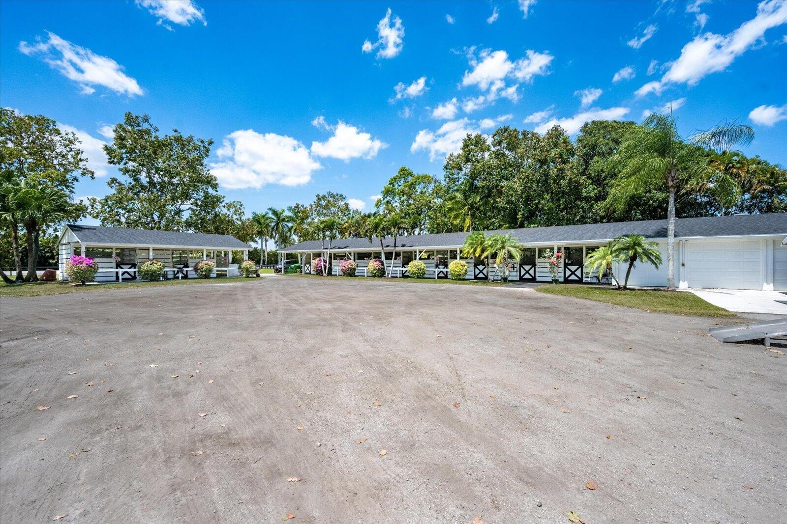 a view of swimming pool with outdoor seating and trees in the background