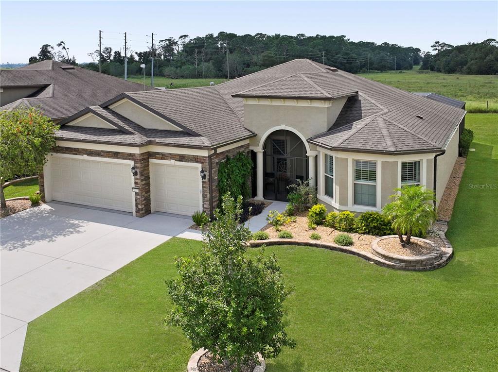 a front view of a house with a garden