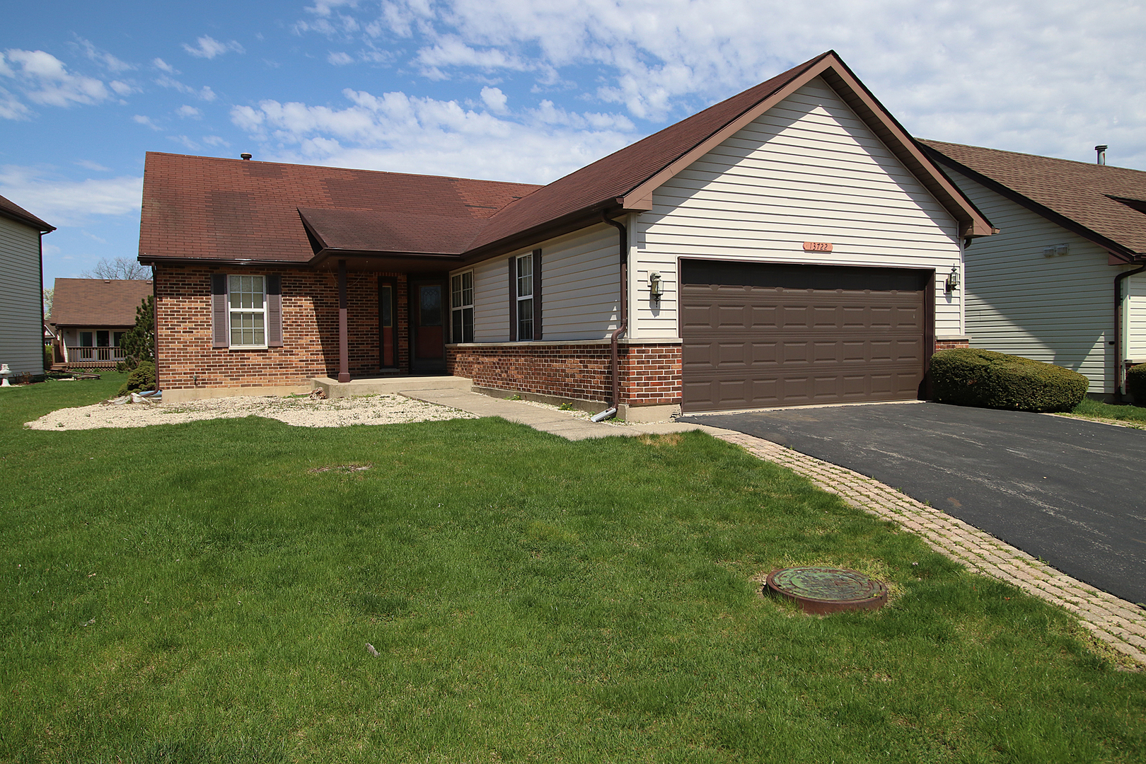 a front view of a house with a yard and sitting area