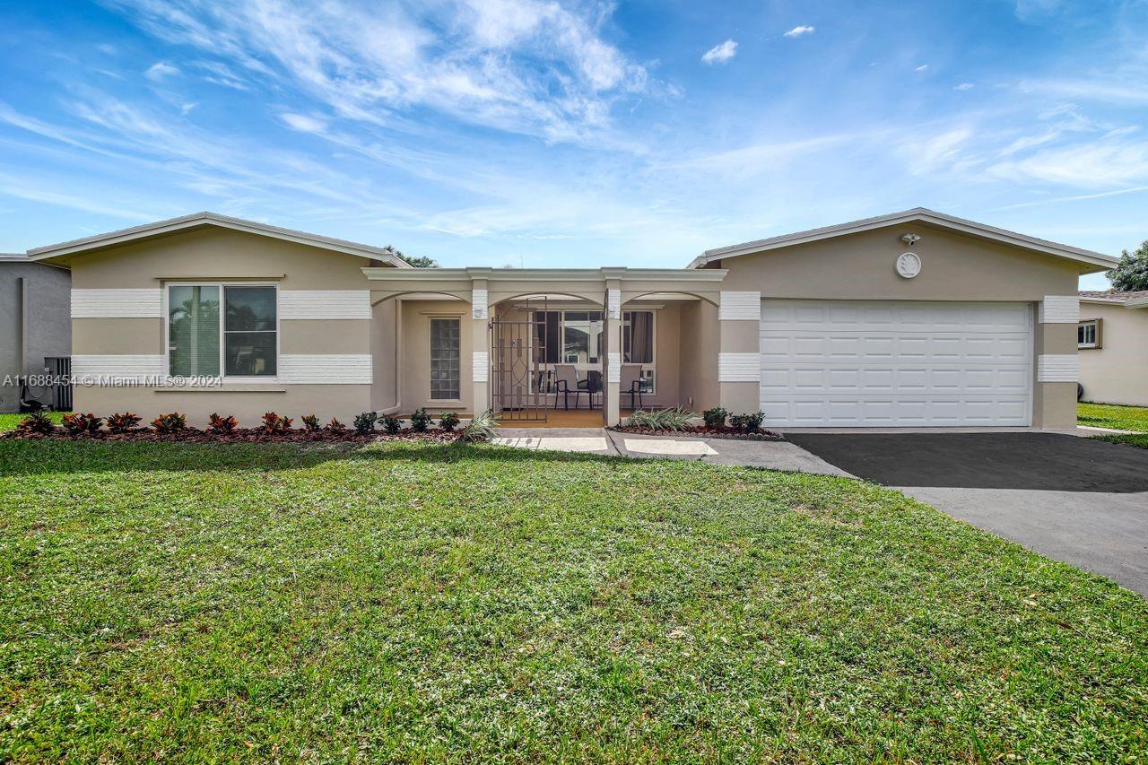 a front view of house with yard and green space