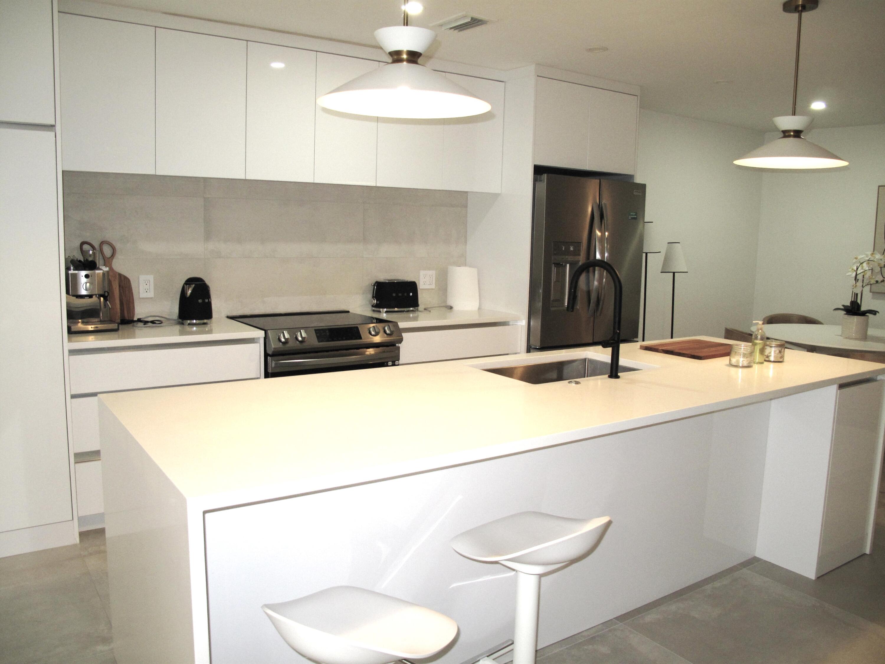 a kitchen with a sink a stove and refrigerator