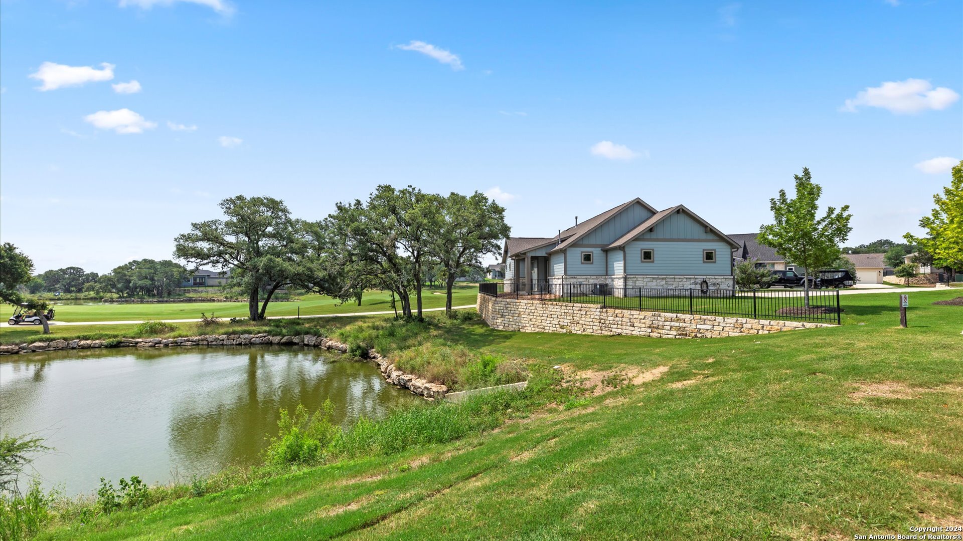 a view of a house with a yard and sitting area