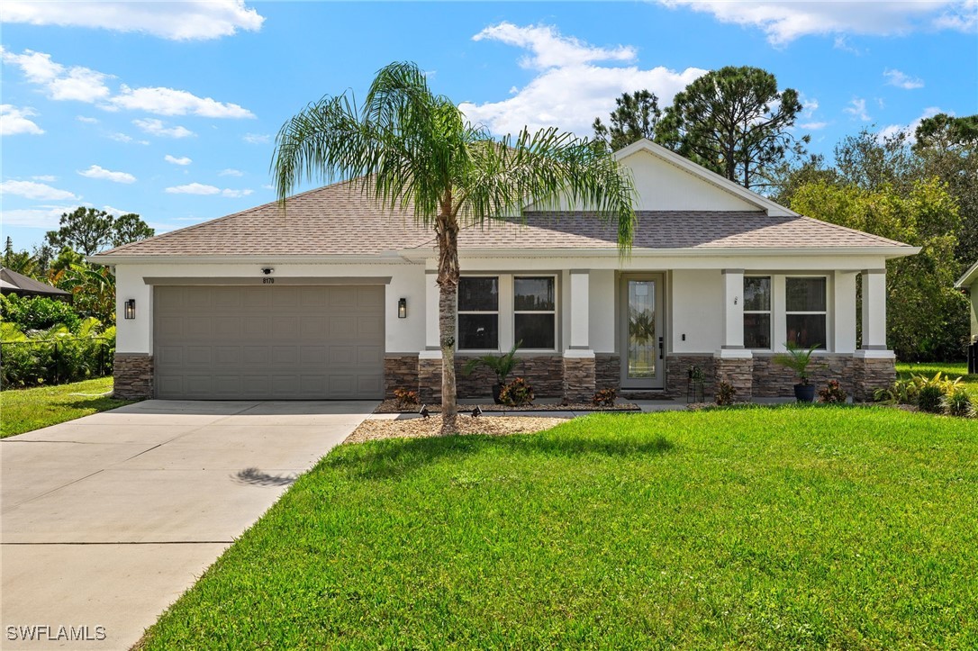 a front view of a house with a yard and garage