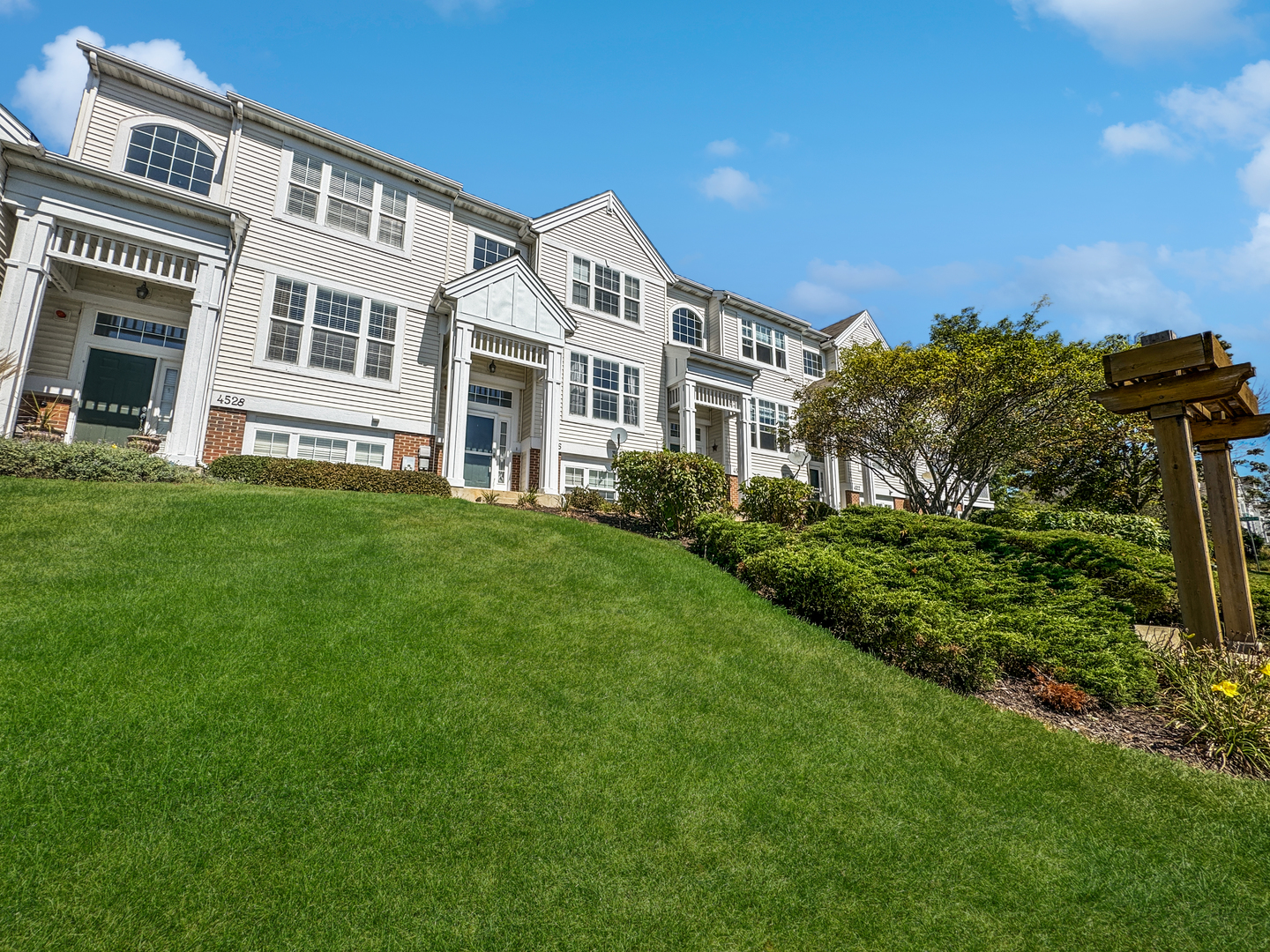 a large building with a big yard and more windows