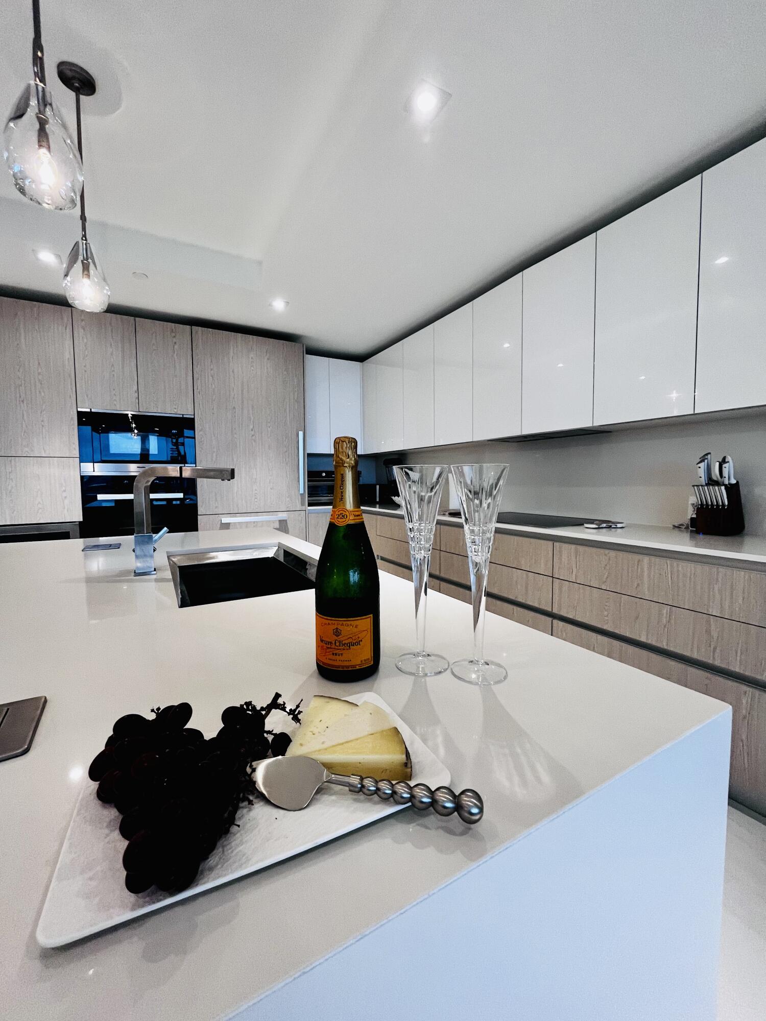 a kitchen with a sink white cabinets and black appliances