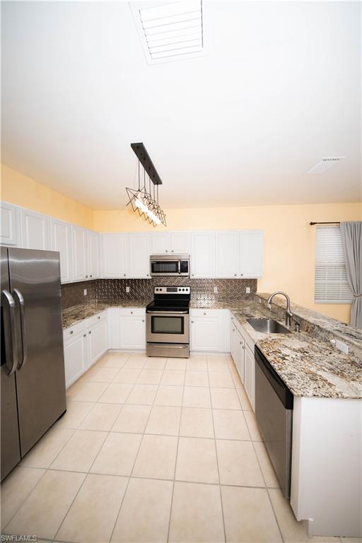 a view of a kitchen with a sink and dishwasher