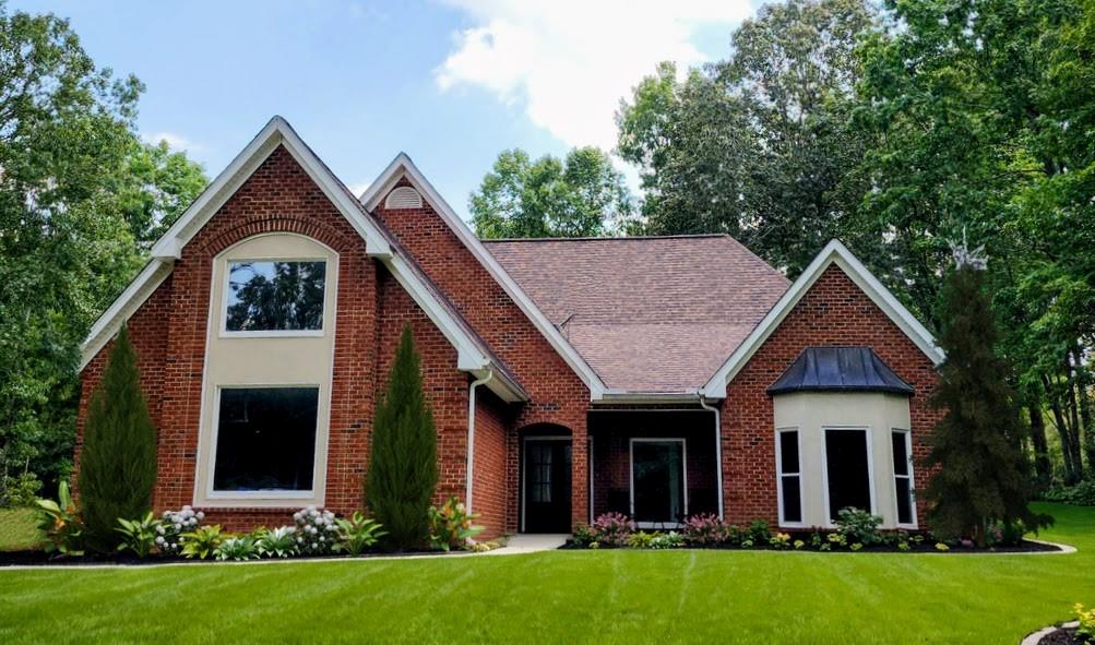 a front view of house with yard and green space