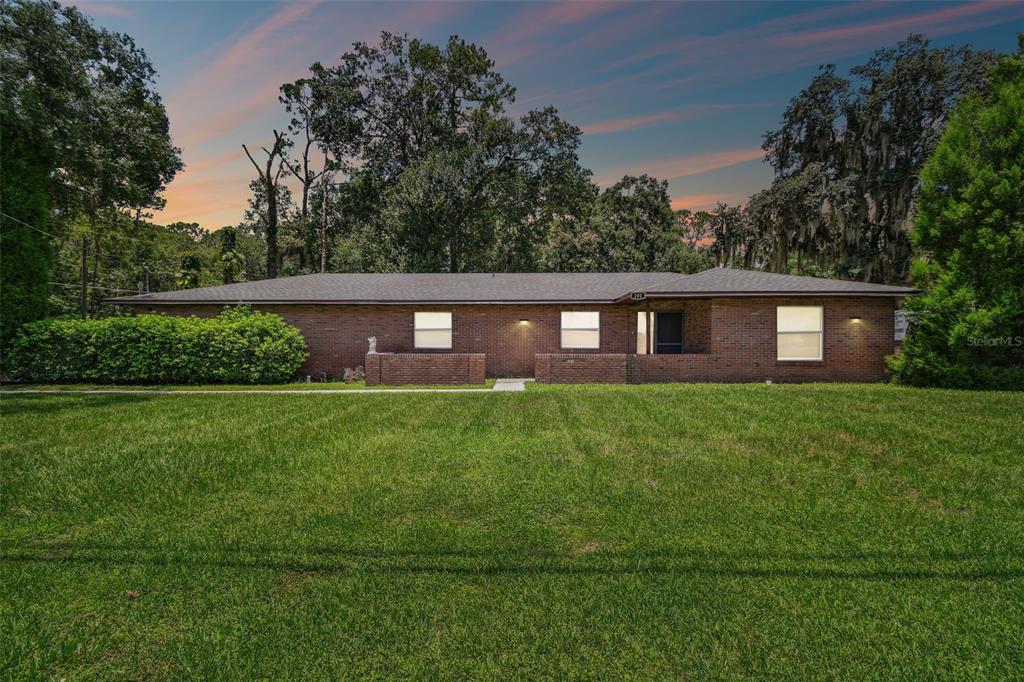 a front view of a house with a yard