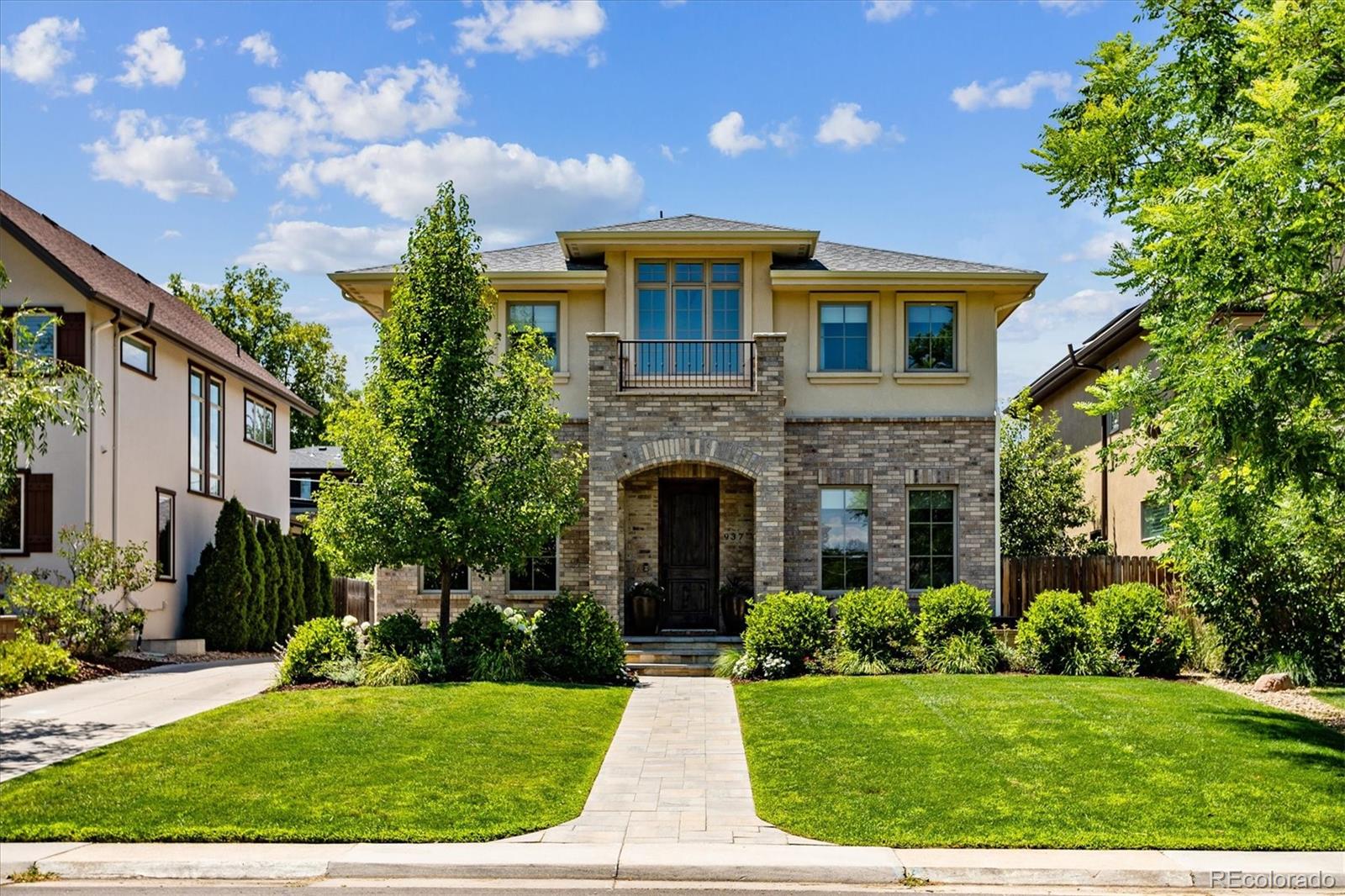 a front view of house with yard and green space