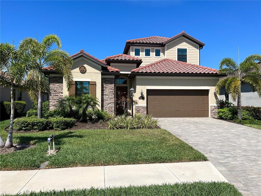 a front view of a house with a yard and garage