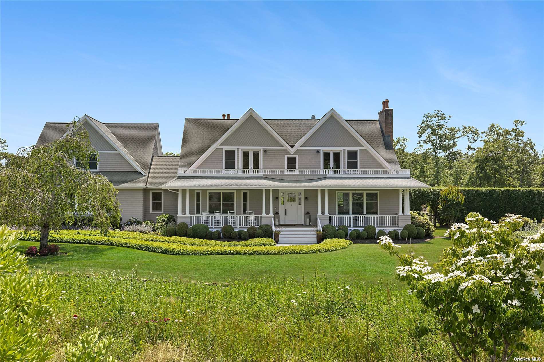 a front view of a house with a garden and plants