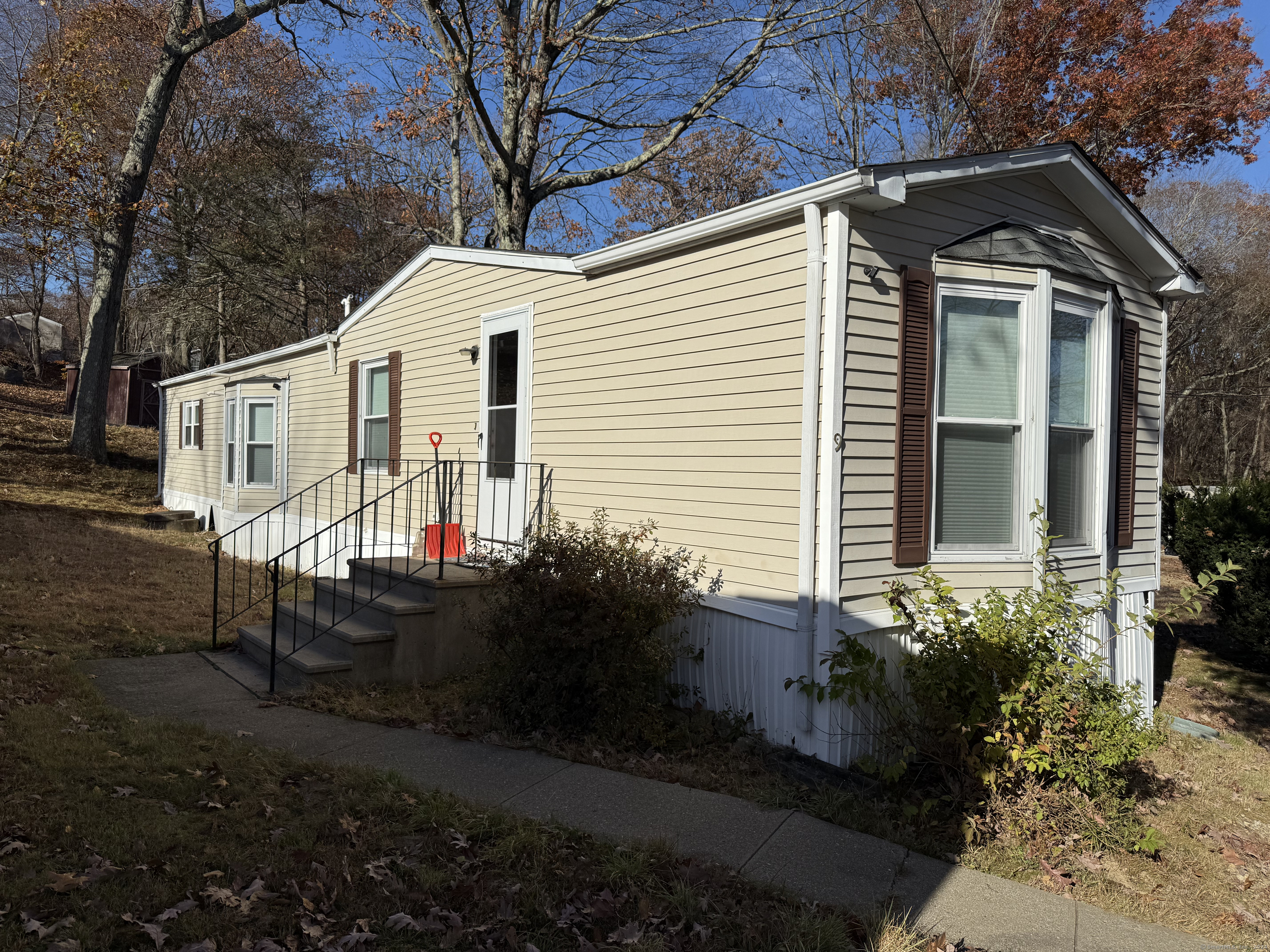 a view of a house with yard and sitting area