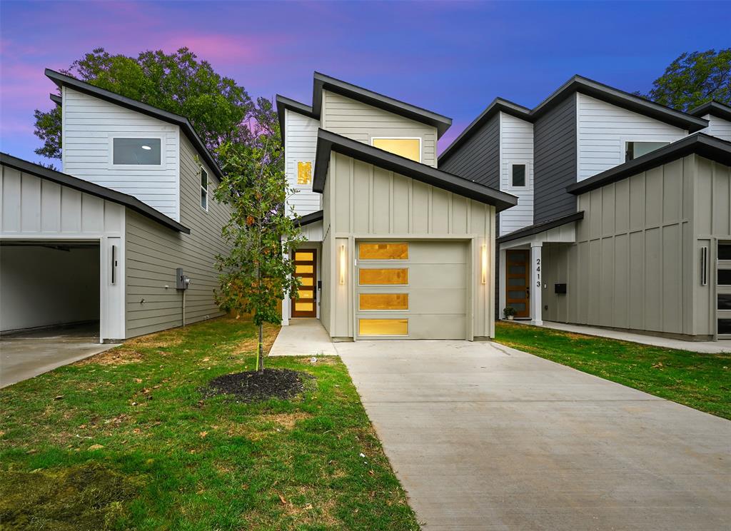 a front view of a house with a yard and garage