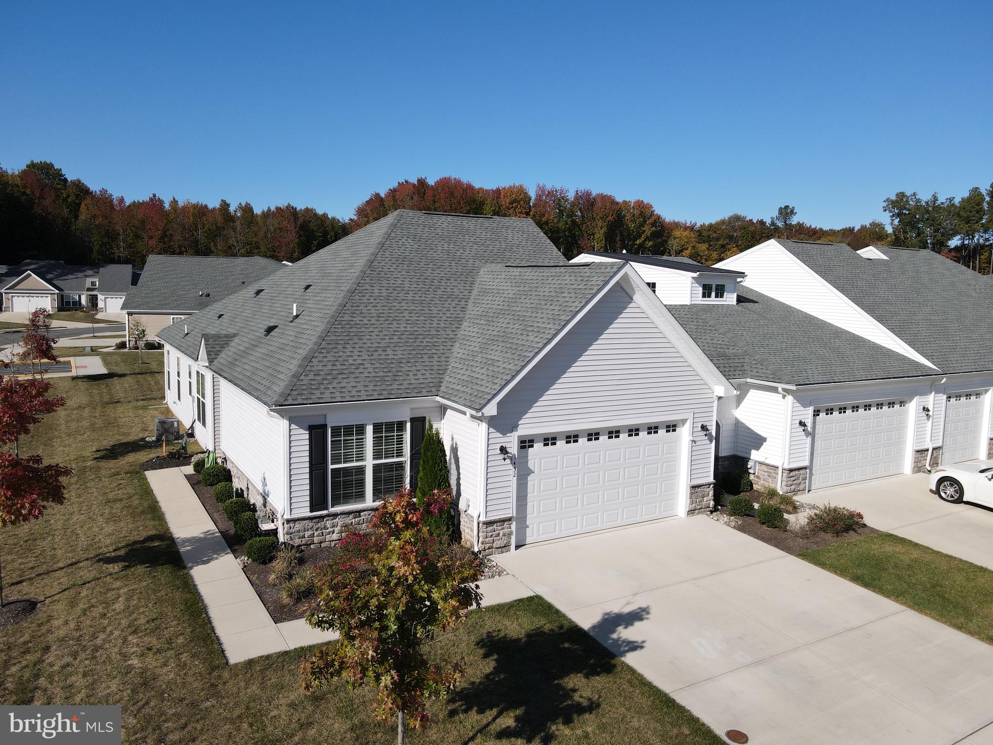 a aerial view of a house with a yard and balcony