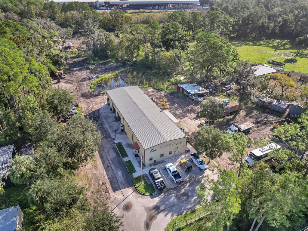 an aerial view of a house with a garden and lake view