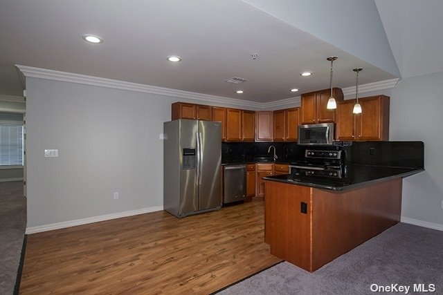 a kitchen with stainless steel appliances granite countertop a refrigerator and a sink