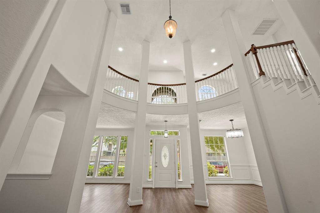 a view of a hallway with wooden floor and entryway