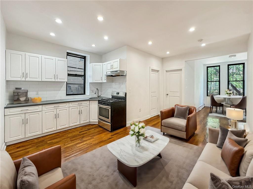 Living room featuring sink and light hardwood / wood-style flooring