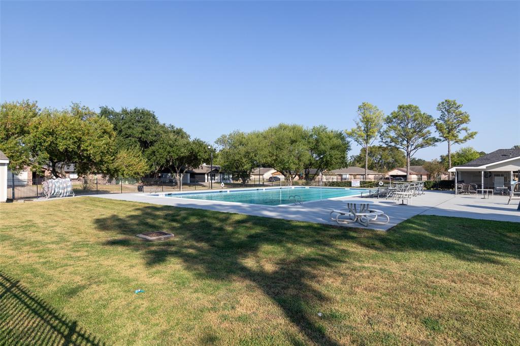 a view of swimming pool with a yard