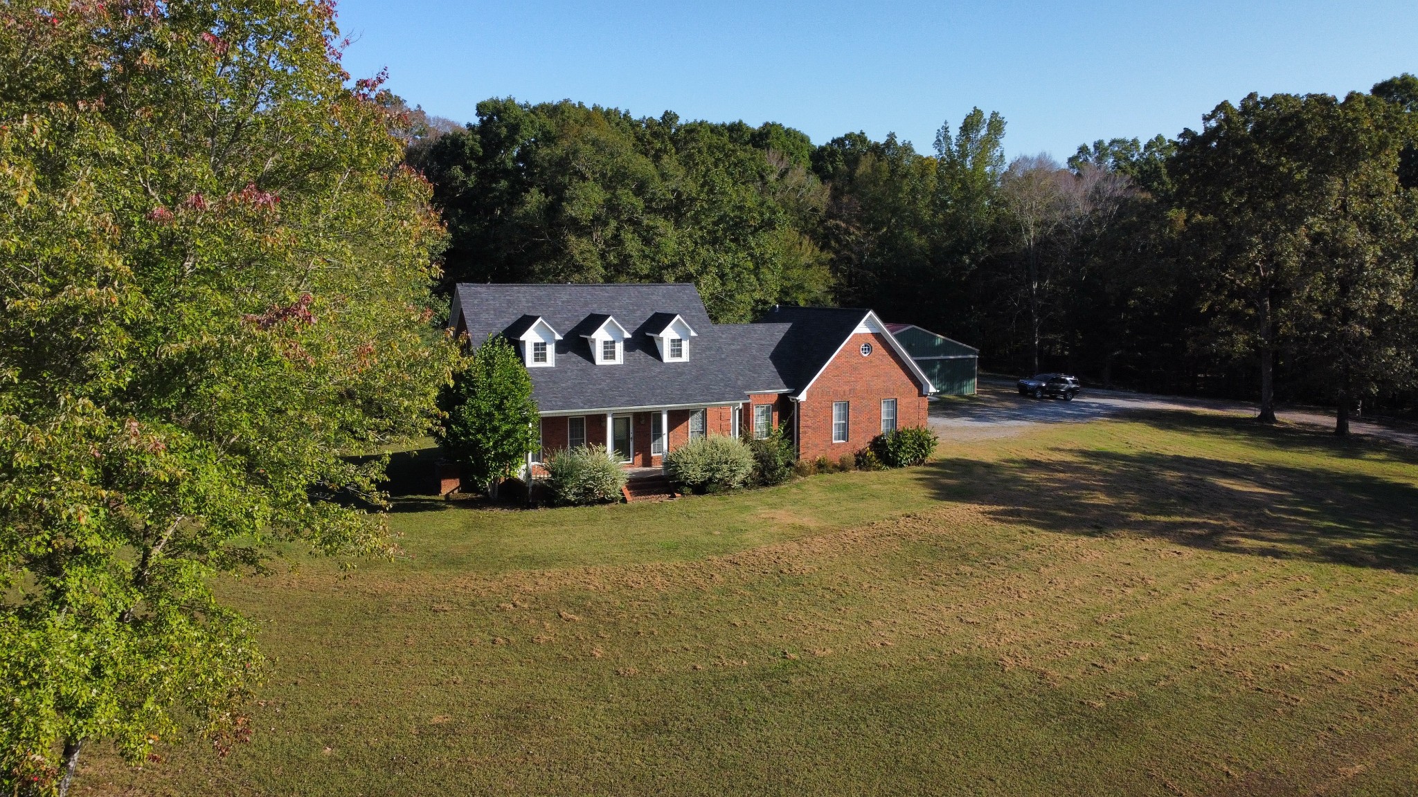 a view of a house with swimming pool and a yard