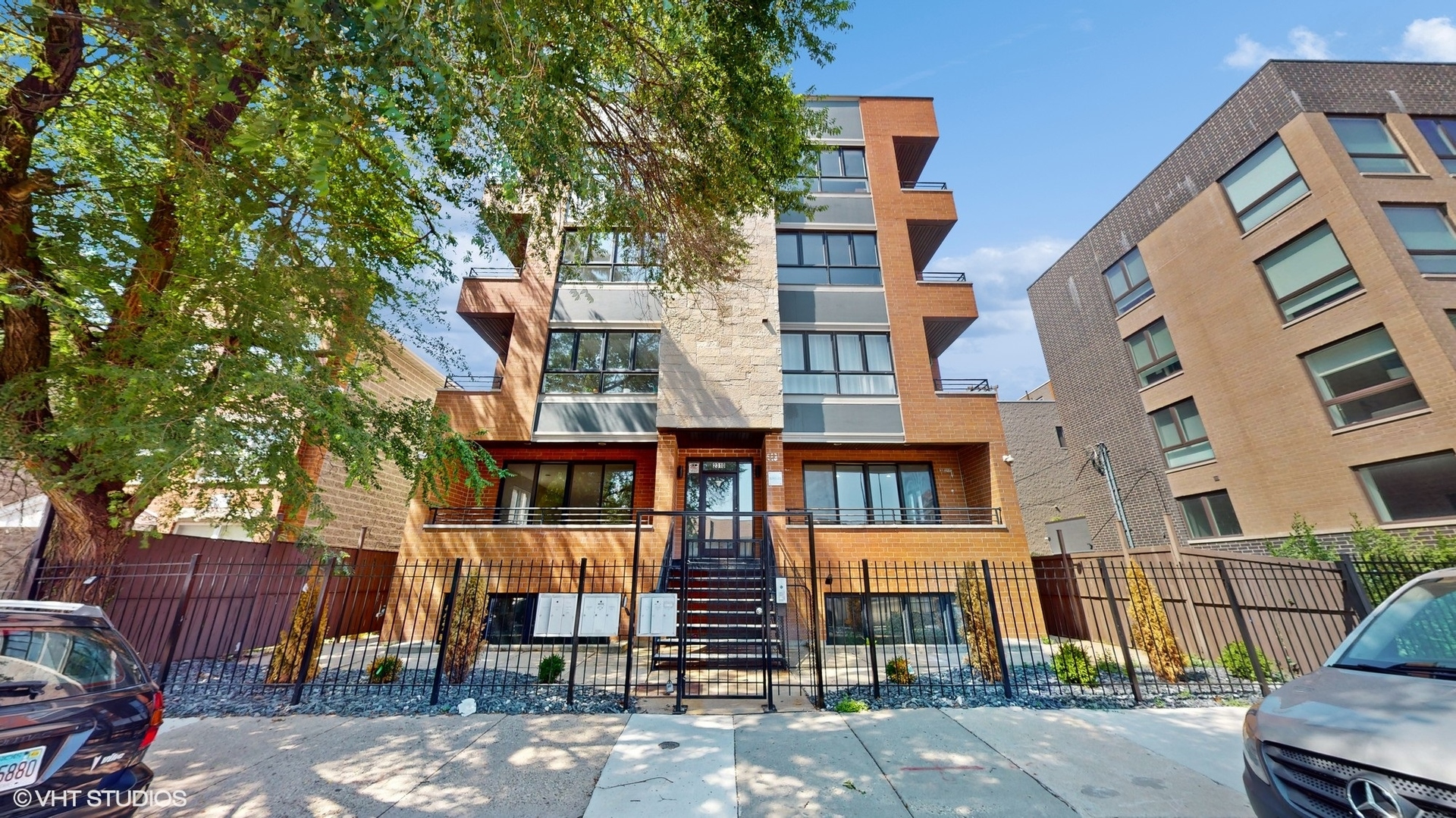 a front view of a multi story building with yard