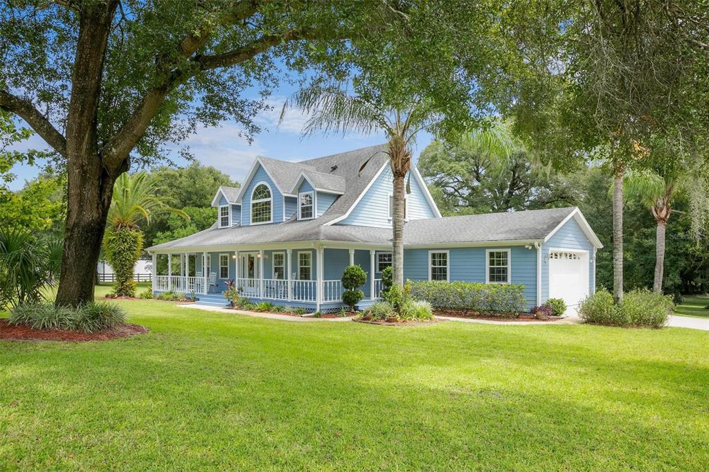 a front view of a house with a garden and plants