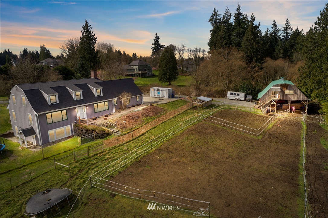 a view of yard with swimming pool and trees in the background