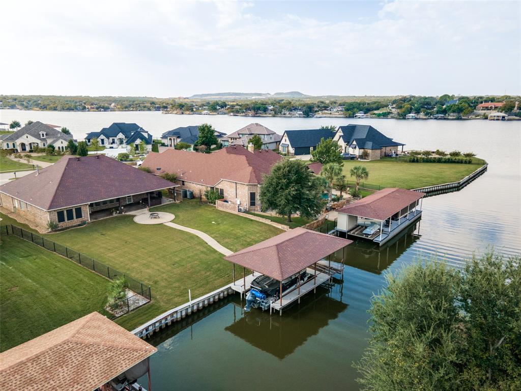 an aerial view of a house with outdoor space and lake view