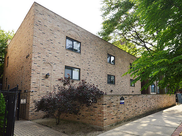 a front view of a house with trees