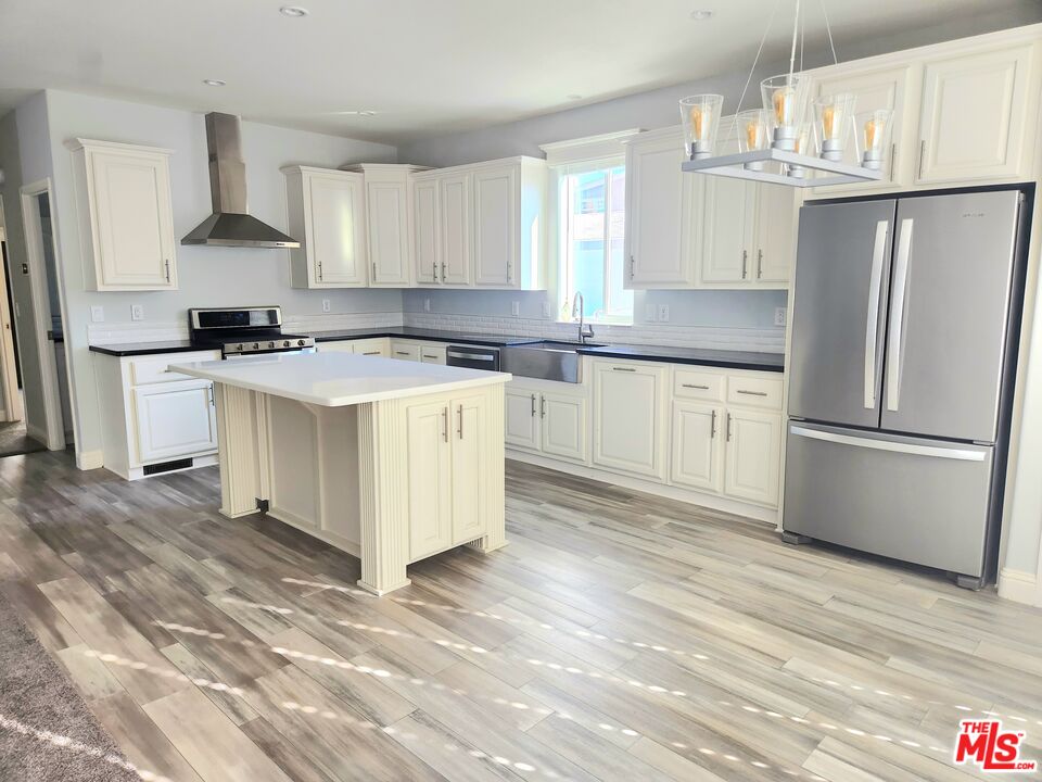 a kitchen with a white cabinets and refrigerator