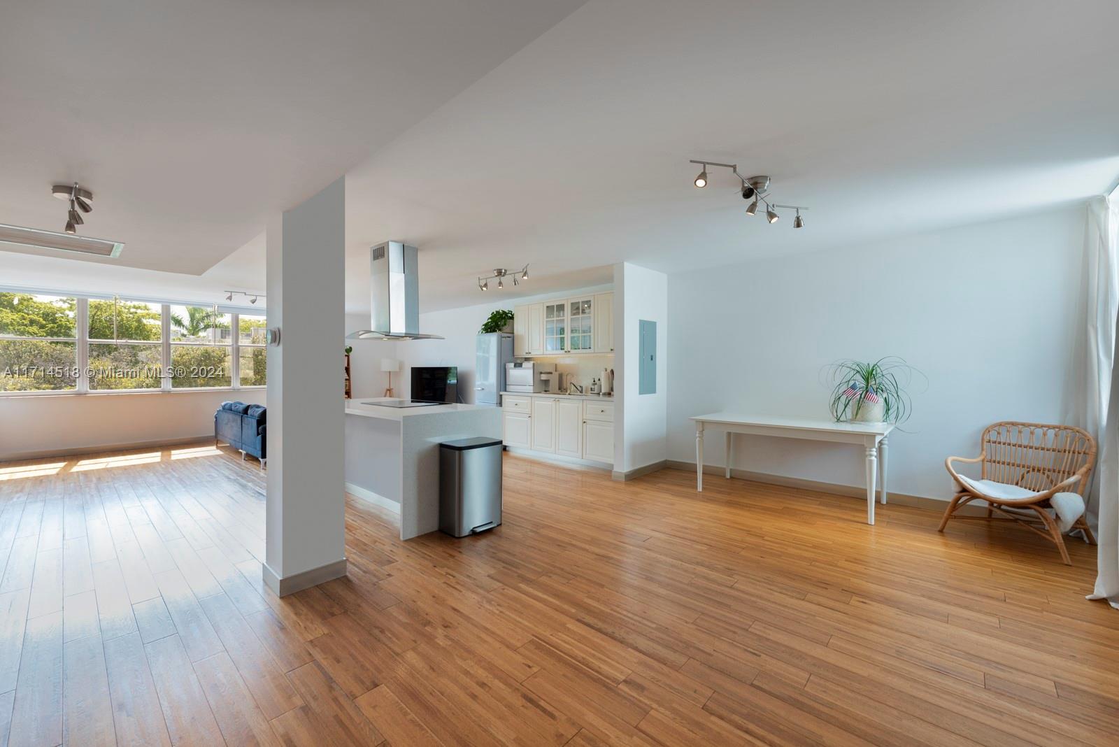 a view of a livingroom with furniture wooden floor and a window