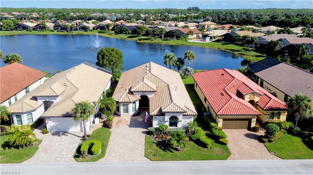 an aerial view of a house with outdoor space and lake view