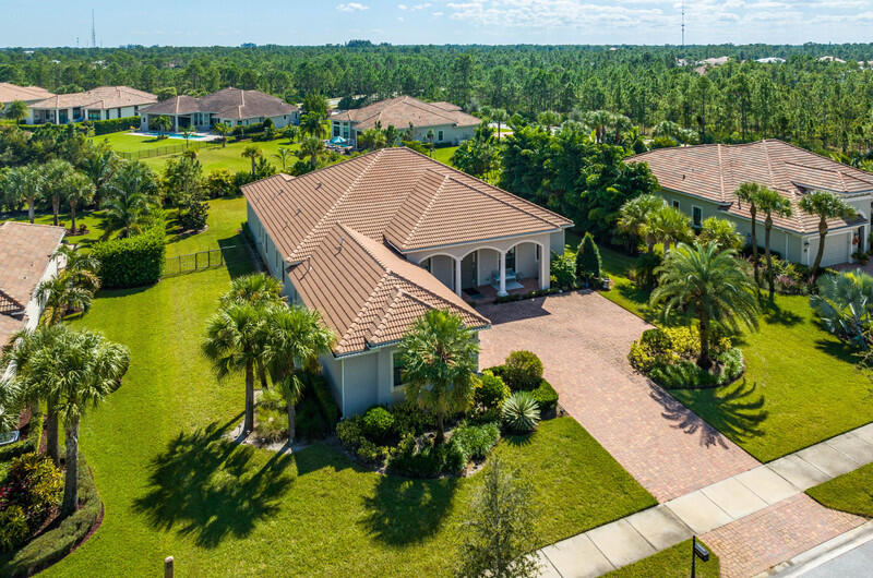 an aerial view of a house with yard swimming pool and outdoor seating