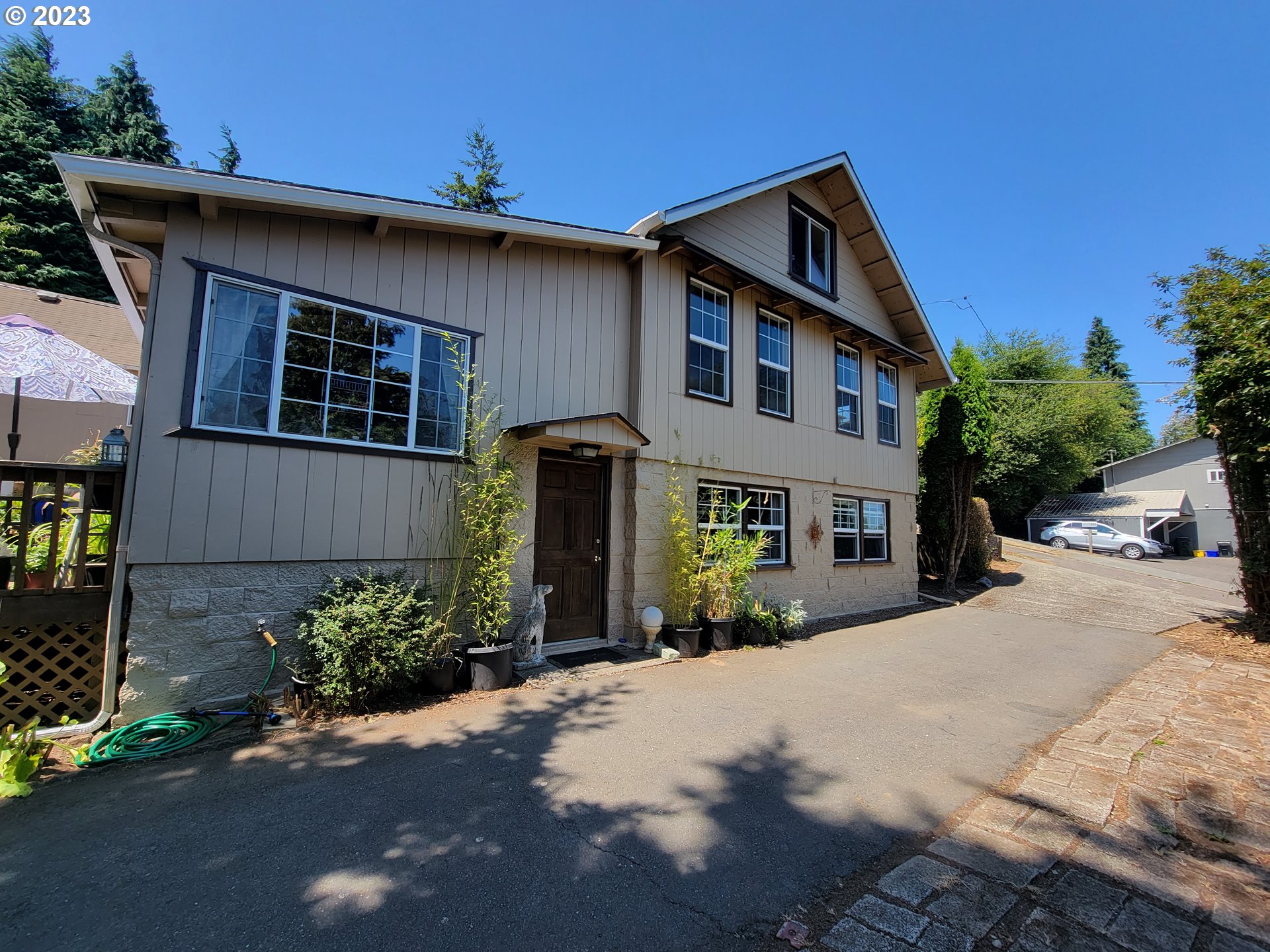 a front view of a house with a yard and a garage