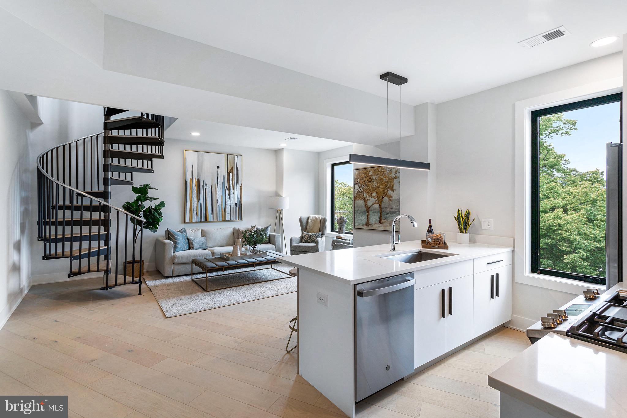 a kitchen with a sink and living room