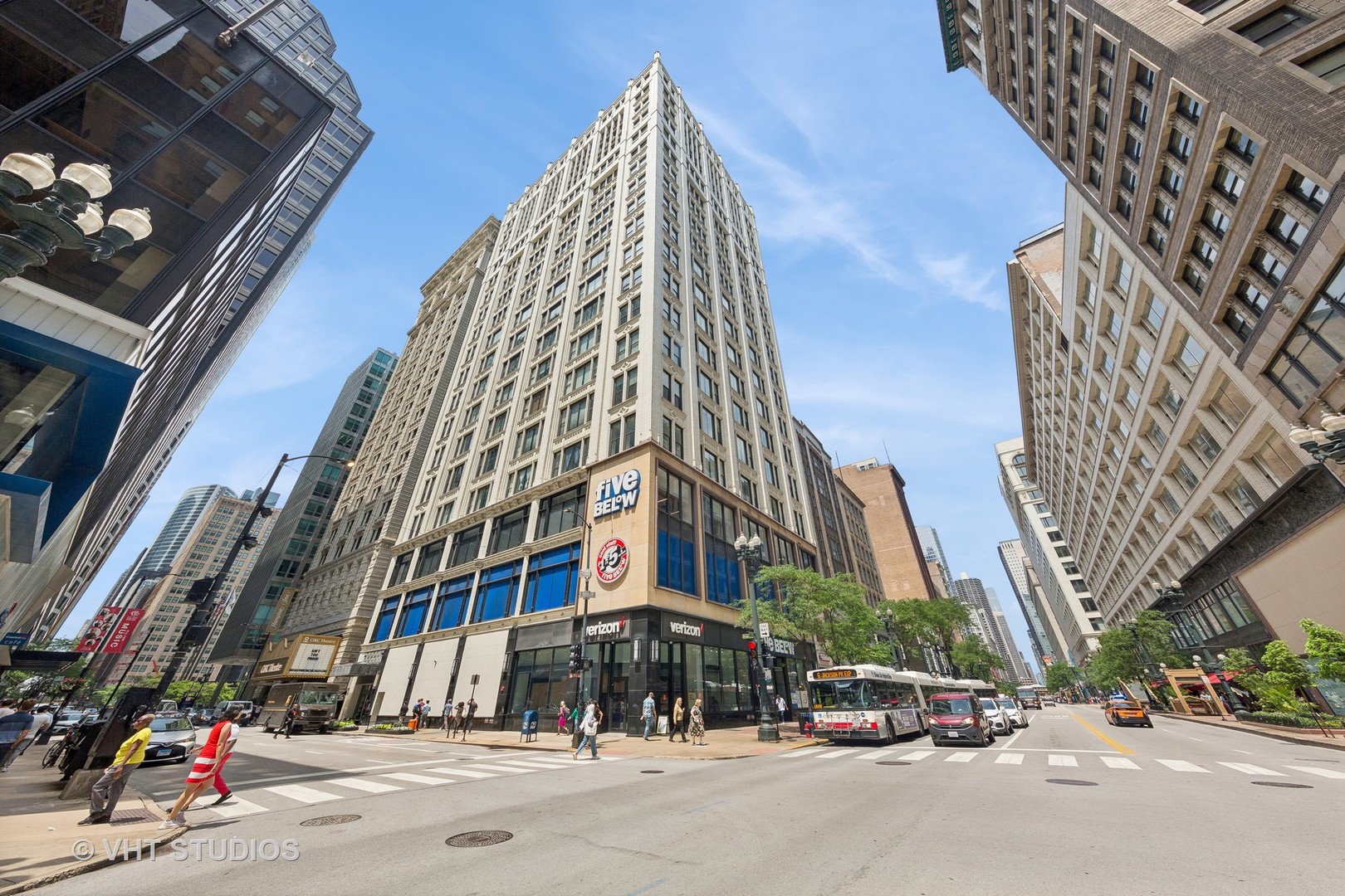 a city street with tall building next to a road