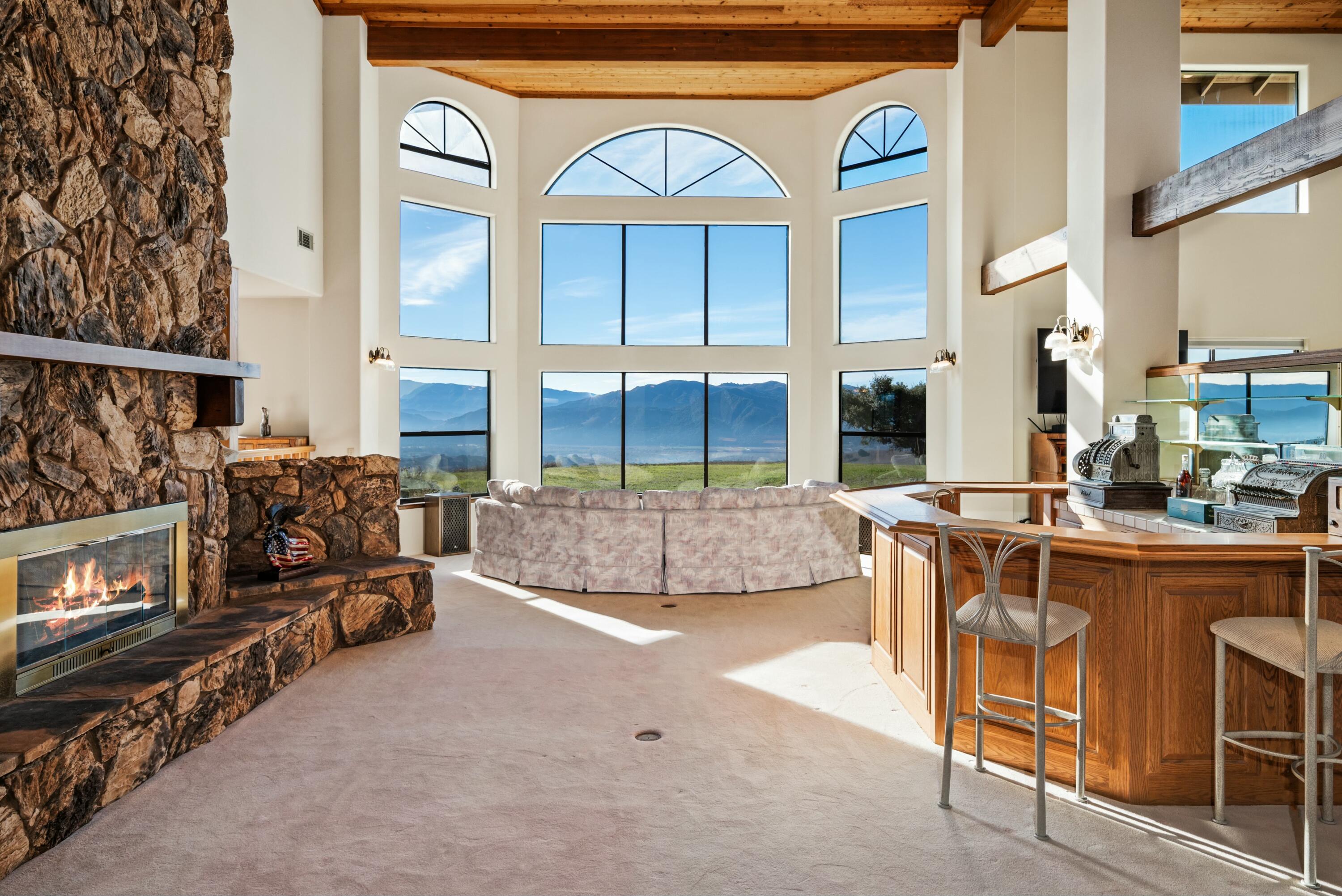 a view of living room kitchen with furniture and fireplace