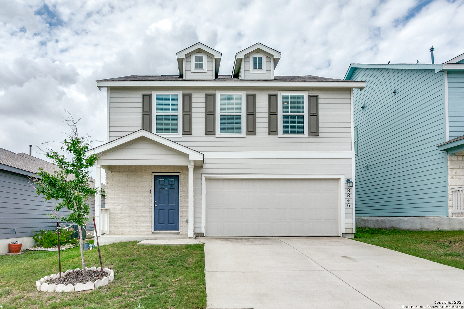 a front view of a house with a yard and garage