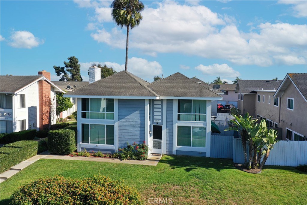 a front view of a house with a garden and plants