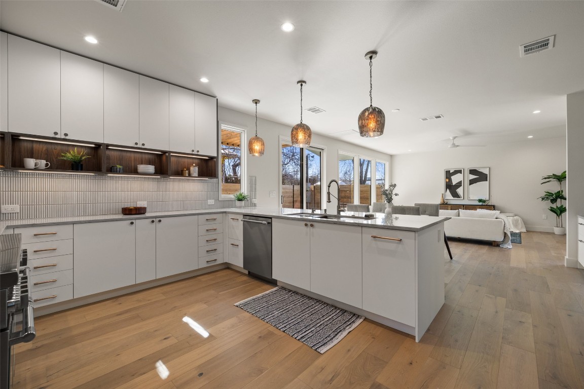 a kitchen with a sink appliances and cabinets