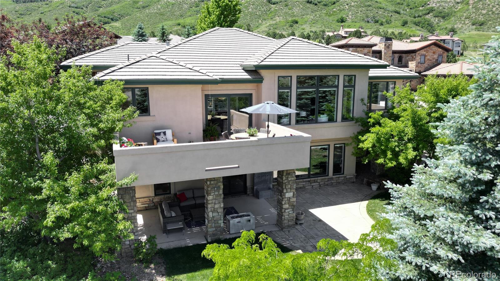 an aerial view of a house with a patio table and chairs